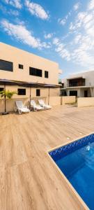 a patio with chairs and a swimming pool on a building at Luxury Villa at THE HIDDEN DOMUS I Trassaco, East Legon in Accra