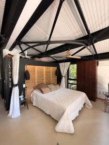 a bedroom with a large bed in a room at VILLA Nîmes tourmagne PISCINE in Nîmes