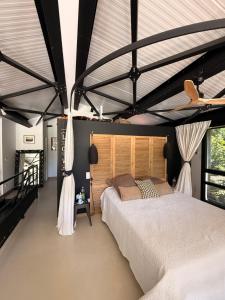 a bedroom with a large bed with a wooden headboard at VILLA Nîmes tourmagne PISCINE in Nîmes