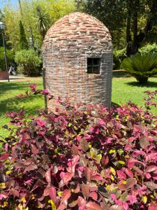 a pile of flowers in front of a brick structure at Hotel Cavalieri Del Mare in Marina di Massa