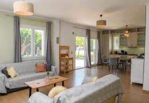 a living room with two couches and a table at Anasa Villas in Mythimna