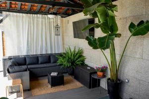 a living room with a couch and some plants at Quinta Tapada do Vale in Vila Meã