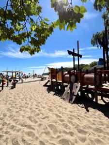 a playground on a sandy beach with a play area at Gdynia Abrahama 48 in Gdynia