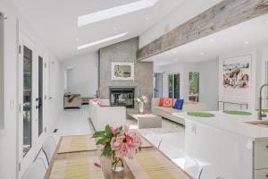 a living room with white furniture and a fireplace at Villa Sapphire Bay in Sag Harbor