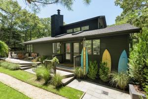 a house with surfboards on the side of it at Villa Sapphire Bay in Sag Harbor