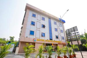 a hotel building with trees in front of it at FabHotel Status Residency in Mumbai