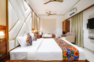 a hotel room with a large bed and a tv at FabHotel Status Residency in Mumbai +37 photos