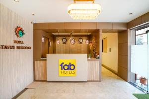 a lobo hotel lobby with a sign on the wall at FabHotel Status Residency in Mumbai