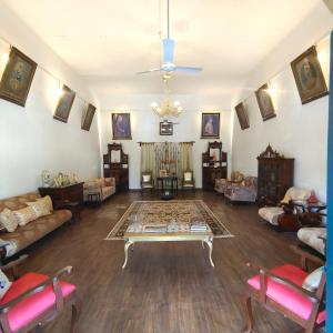 a living room with a table in the middle of it at AM Hotel Kollection- Maangarh, Ratlam in Sailāna