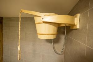 a shower in a bathroom with a wooden shower head at Chata Michala in Dolný Kubín