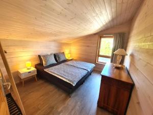 a bedroom with a bed in a wooden cabin at Finn Lodge in Saint-Denis-dʼOléron