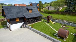 an overhead view of a house with a playground at Traditional deer Cabin with Sauna - Chata Srňacie in Dolný Kubín