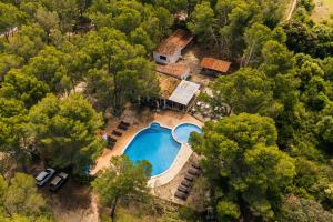 an aerial view of a house with a swimming pool at Kampaoh Menorca in Cala Galdana +33 photos