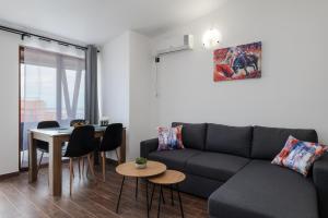 a living room with a couch and a table at Transilvaniya Apartments in Sozopol
