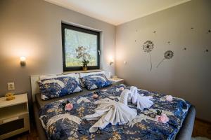 a bedroom with a bed with towels on it at Vista Apartment With Hot Tub & Large Terrace in Leskovec pri Krškem