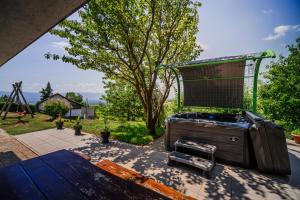a backyard with a bird cage and a playground at Vista Apartment With Hot Tub & Large Terrace in Leskovec pri Krškem +36 photos