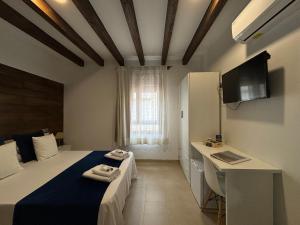 a bedroom with a bed and a desk in it at habitaciones tabarca in Tabarca