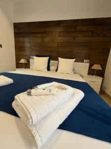 a bedroom with two beds with towels on the bed at habitaciones tabarca in Tabarca
