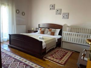 a bedroom with a large bed and a rug at Stone House Berat in Dushnik