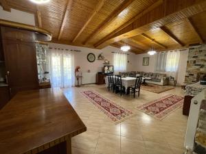a large living room with a table and chairs at Stone House Berat in Dushnik