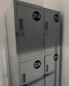 a row of four lockers with numbers on them at The Soul Hostal in Playa del Carmen