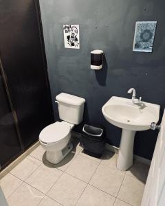 a bathroom with a toilet and a sink at The Soul Hostal in Playa del Carmen +34 photos