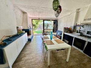 a kitchen with a table with chairs and a dining room at Villa stella di mare in Capitana