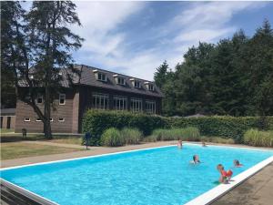 a group of people playing in a swimming pool at Ons Boshuys C18 in Garderen