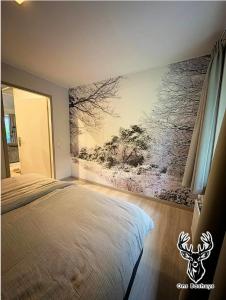 a bedroom with a bed and a painting on the wall at Ons Boshuys C18 in Garderen +18 photos