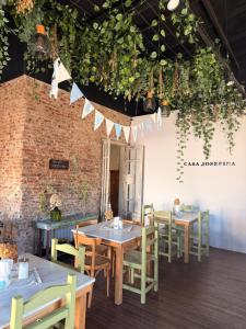 a dining room with tables and chairs and plants at Casa Josefina Hotel Boutique in Olavarría