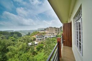 a balcony with a view of trees and buildings at Kaizen Stay-Inn in Jowai