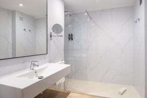 a white bathroom with a sink and a shower at htop Pineda Palace SPA 4Sup - Bliss - Adults Only Plus 18 in Pineda de Mar