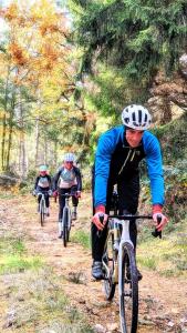 a group of people riding bikes down a trail at La Butinerie in Prévenchères