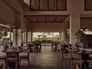 a restaurant with tables and chairs in a room at OKU Andalusia in La Alcaidesa