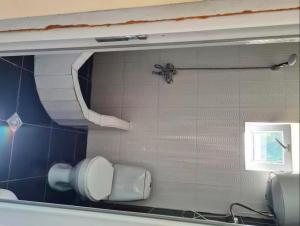 a mirror in a bathroom with a toilet paper dispenser at Debi in Gulida