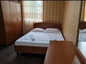 a bedroom with a bed with a phone on it at Debi in Gulida