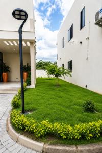 a street light in a yard next to a building at Luxury Villa at THE HIDDEN DOMUS I Trassaco, East Legon in Accra