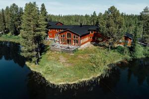 an aerial view of a large house on an island in the water at Pinetree Lodge in Kangos