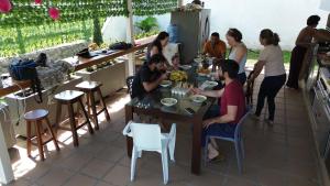 a group of people sitting at a table eating food at Glamping Guacharaca cerca de Bogotá con vistas a la montaña in Silvania