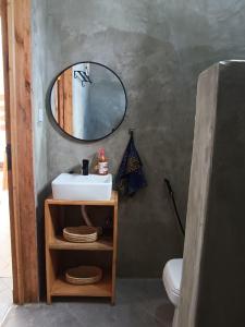 a bathroom with a sink and a mirror at Ubuntu Home in Mto wa Mbu