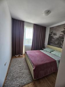 a bedroom with a large bed and a window at SOLITA Apartment with Panoramic View in Byala