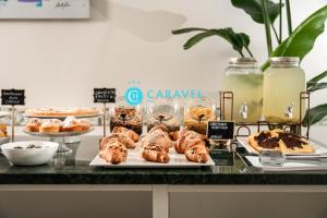 a buffet of pastries and desserts on a counter at Hotel Caravel B&B in Misano Adriatico