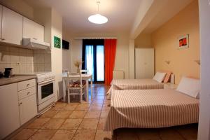 a kitchen with two beds in a room at Ikos Studios and Apartments in Patitiri +44 photos