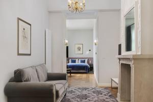 a living room with a couch and a fireplace at Wyndham Grand Krakow Old Town in Krakow +49 photos