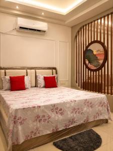 a bedroom with a bed with red pillows at Skyline Zirakpur in Zirakpur