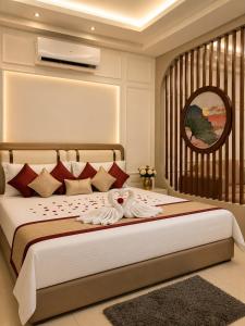 a bedroom with a bed with two swans on it at Skyline Zirakpur in Zirakpur