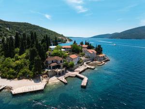 an island in the middle of a body of water at Stone Rose Glamping & Apartments in Tivat