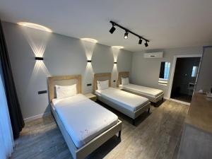 a room with two beds and lights on the wall at Duman Boutique Hotel Cesme in Çeşme +32 photos