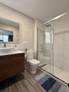 a bathroom with a shower and a toilet and a sink at Chalet en el mar in La Manga del Mar Menor +61 photos