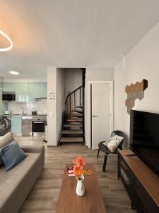 a living room with a couch and a table at Chalet en el mar in La Manga del Mar Menor